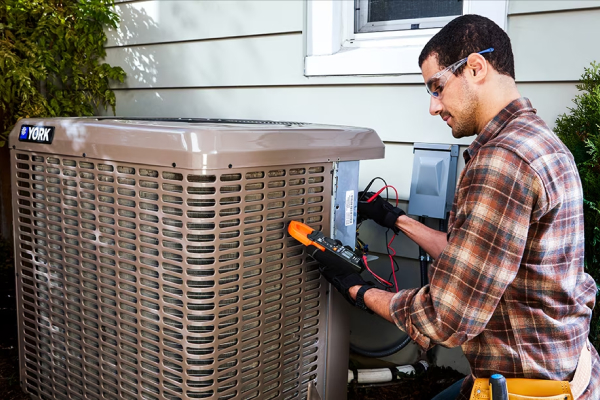 a man working on a york air conditioner outside